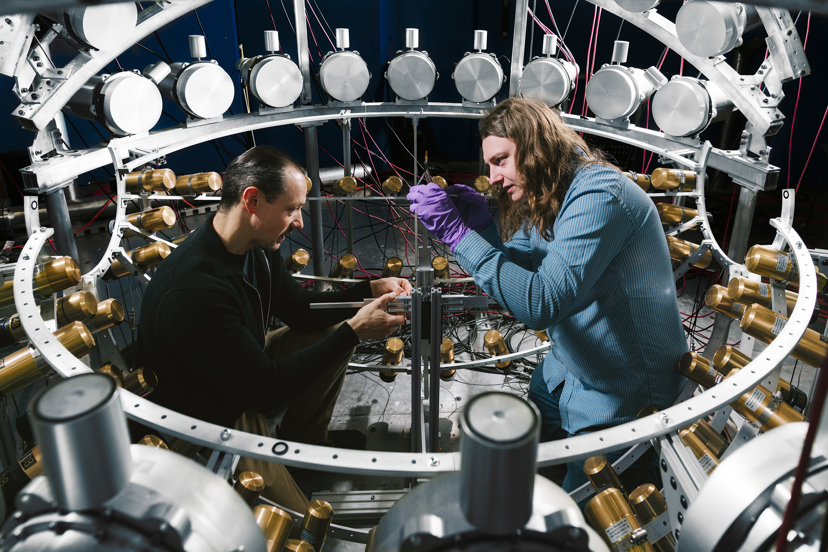 Experimental scientists adjusting the target inside CoGNAC.