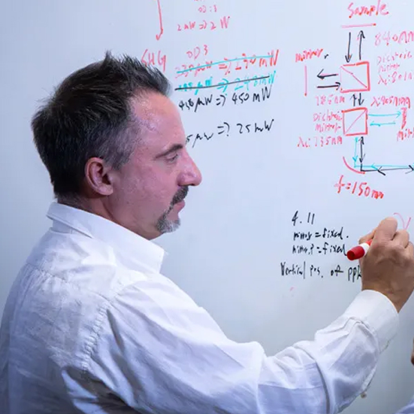 Diego Dalvit writing on a whiteboard