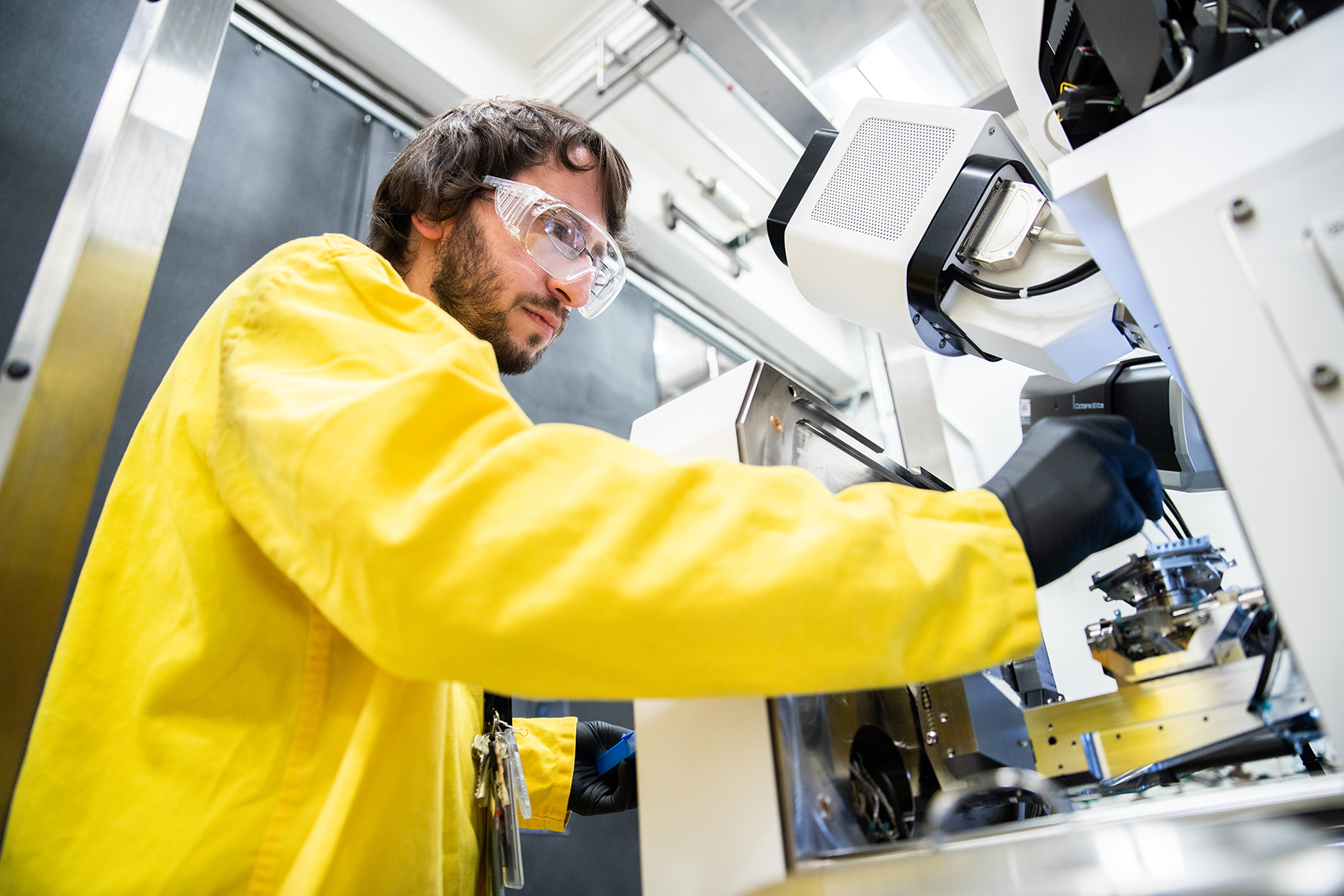 A Pit Production worker working with a sample.