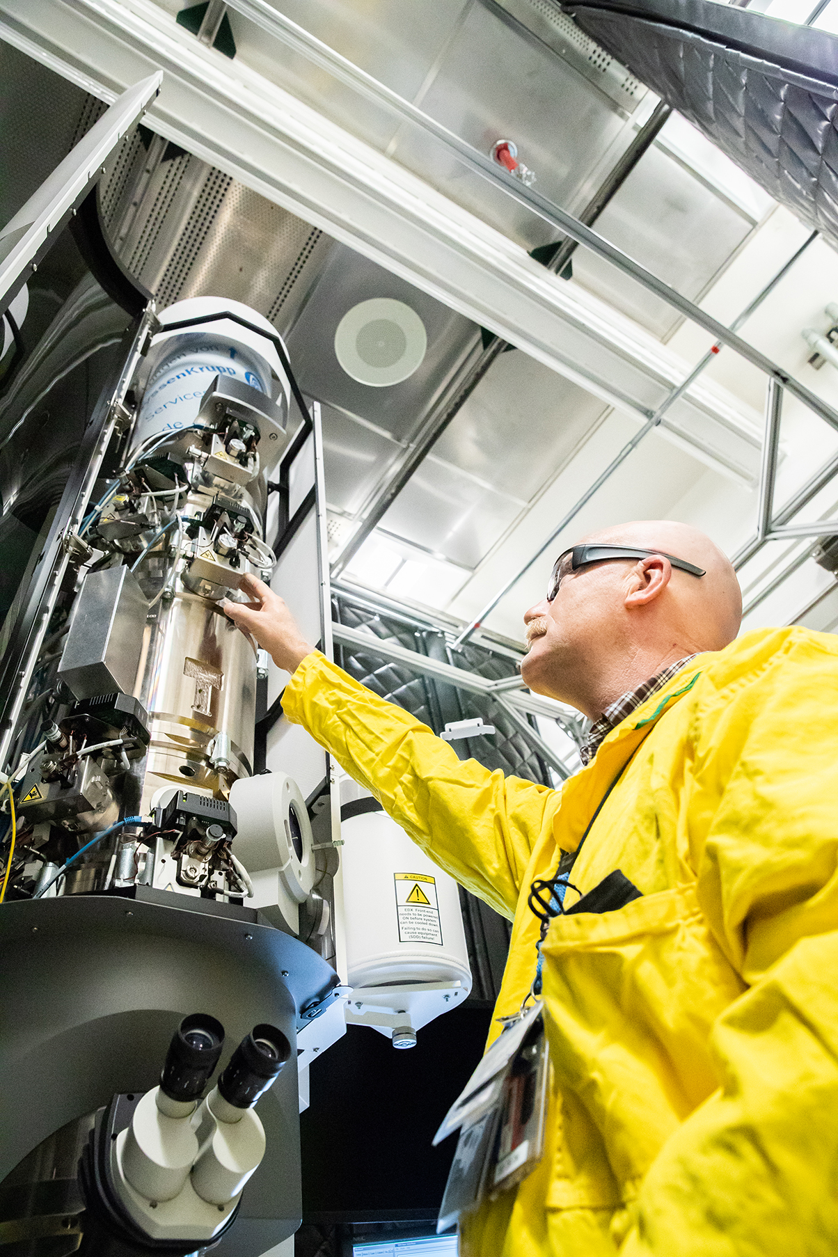 A Pit Production worker checking an instrument.