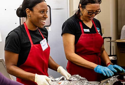 Tamika Gordon (left) volunteering at Santa Fe nonprofit Kitchen Angels.
