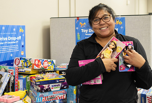 Mariahjozzel Agustin holding gifts from holiday drive