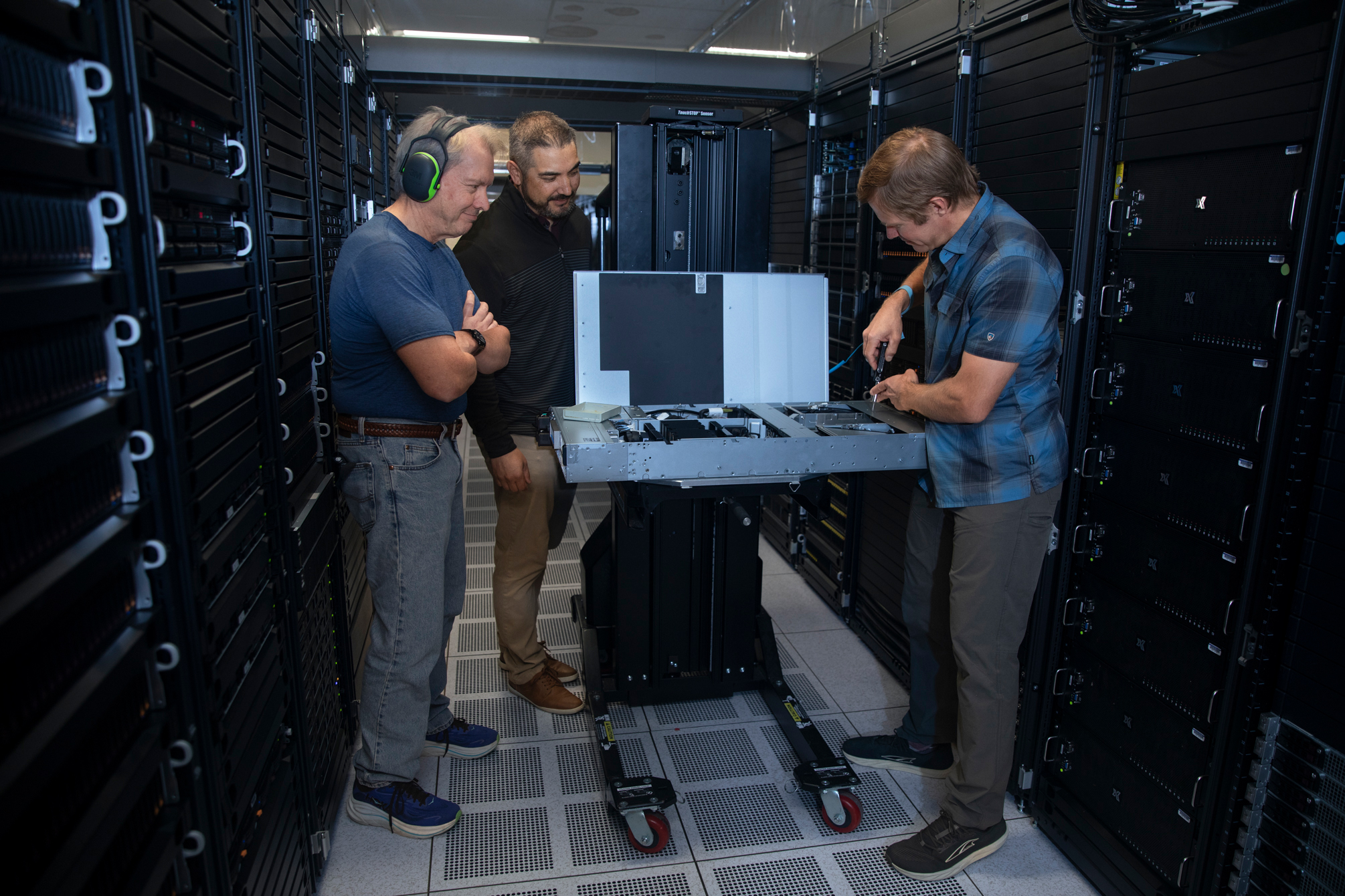 members inspect the system at its testbed location