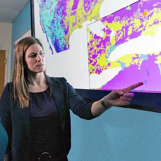 Morgan Gorris pointing at a tv monitor