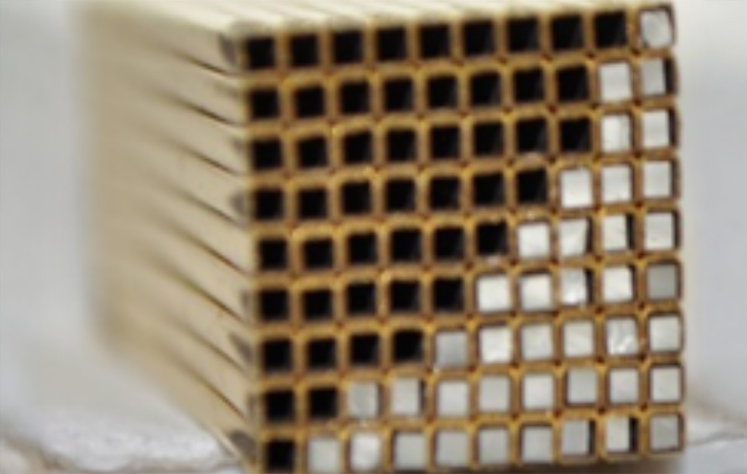 Cross-section of an electroplated scintillator grid array fabricated from high-Z metals. The structure demonstrates uniform, micron-scale channel alignment achieved through electrochemical deposition and hot isostatic pressing.