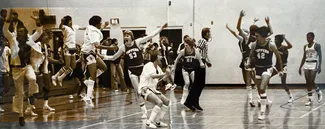 Gilbert Ratliff, second from right, celebrates the Hilltoppers’ victory moments after sinking his winning free throws.